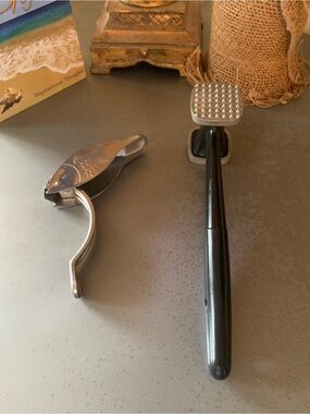Stainless Fish shaped lemon squeezer and a Good Cook 9.5 inch meat tenderizer.